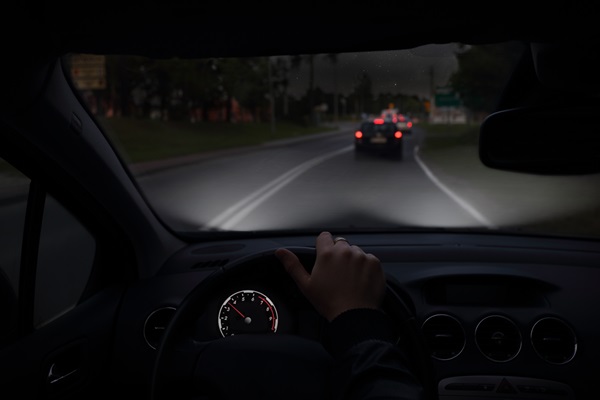 POV of a driver behind the wheel of a car at night.